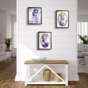 Trois portraits encadrés accrochés sur un mur blanc.